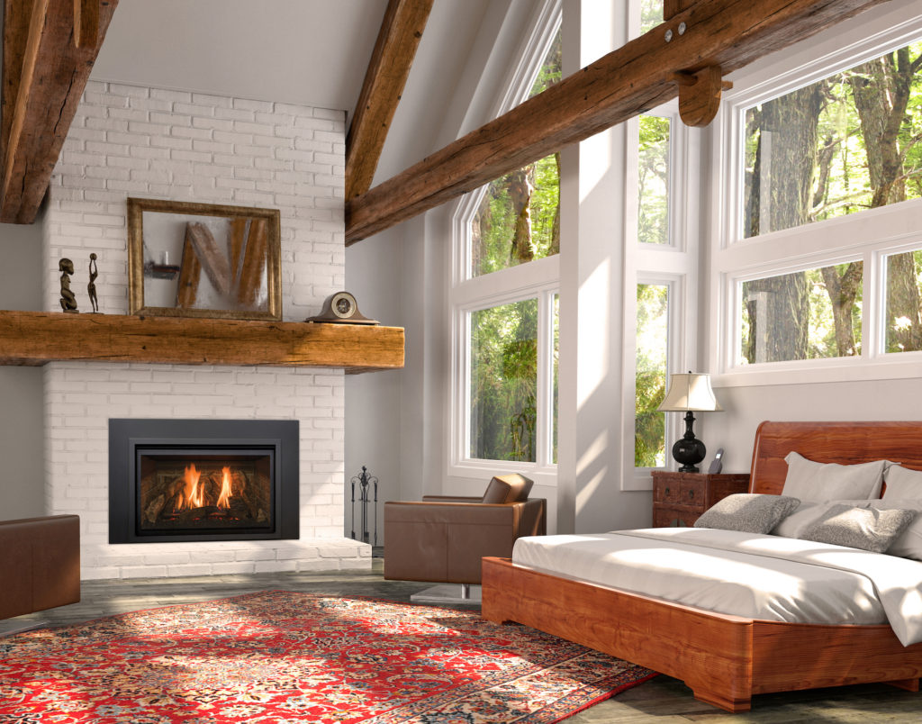 A Kozy Heat Chaska gas insert burning in a white brick fireplace