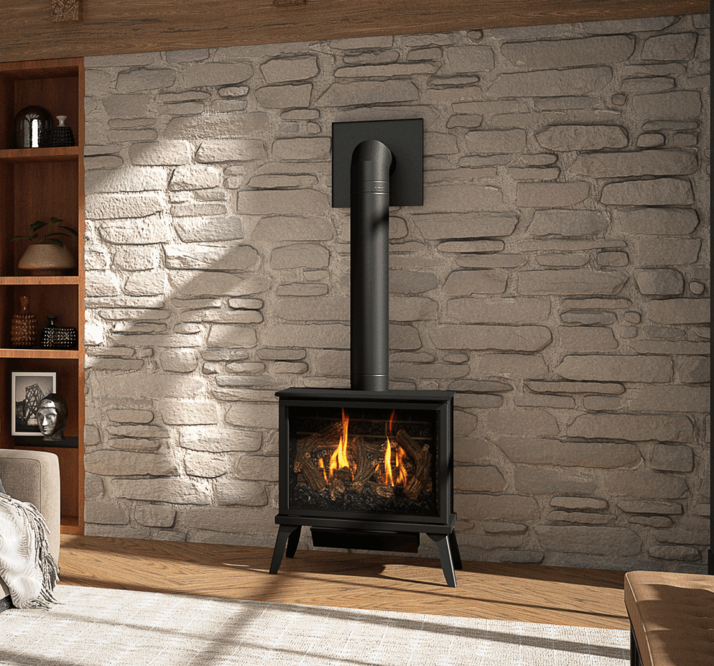A Kozy Heat Lakefield XL gas stove burning against a stone wall